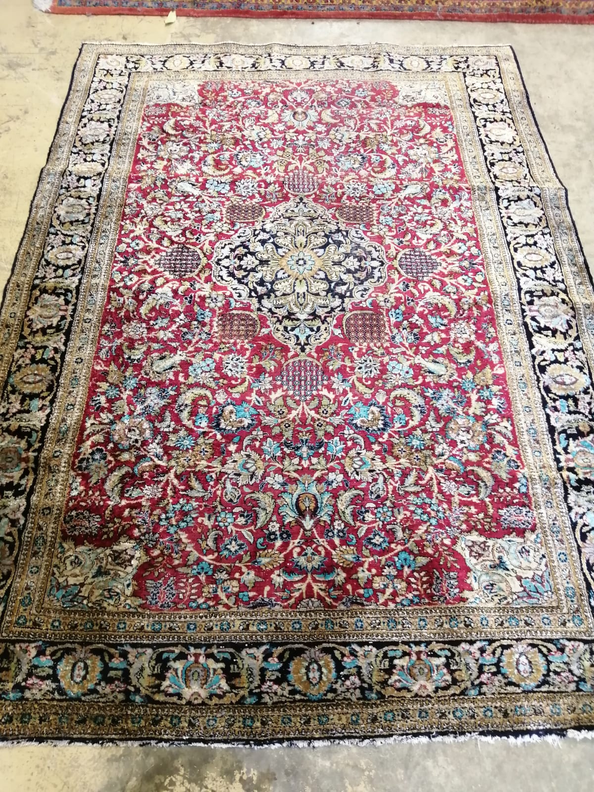 A Tabriz part silk burgundy ground rug, 218 x 150cm